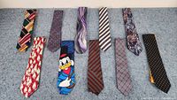 Full view of all 10 neck ties laid flat showing patterns and colors
