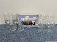 All 10 glasses displayed together showing LuLu's Bait Shack tall glasses, WMF pilsner set in box, and assorted stemmed glasses and small bowls