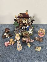 View showing all Boyd's Bears and Friends collectible figurines including Noah's Arc centerpiece with animal pairs and palm tree and 10 bear figurines in various poses with props and pastel clothing colors