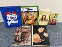 Front cover photo of the six cookbooks showing titles and cover images for baking and dessert recipes.