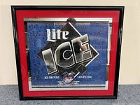Framed Miller Lite Ice mirror sign with blue background, red border, and water droplets design.