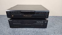 Two Sony CD players stacked on top of each other, Sony CDP-CE345 on top and CDP-C345 on bottom.