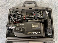 Sony vintage Video8 Handycam camcorder with attached cords in black carrying case