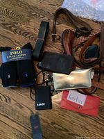 Photo showing Polo Ralph Lauren socks, assorted leather belts, and multiple wallets including metallic silver, brown leather, Koolzie red, and Levi's black wallet