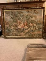 Full front view of tapestry leaning against wall on carpeted floor.