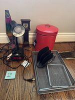Overview of all items including lava lamp, desk lamp, small clock, red trash can, and metal office organizers