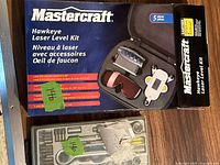 Photo of Mastercraft Hawkeye Laser Level Kit box and carrying case with 5 pieces including the laser device and accessories.
