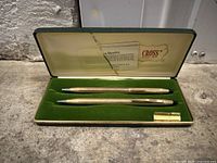 Pair of 10K gold filled Cross pens and pencil on green felt inside original box with brand and quality certificate.