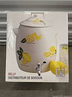 Image of the original box with picture and branding showing the ceramic beverage dispenser and lemon design