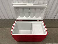 Photo of Coleman cooler interior showing red body and white interior with removable tray.