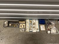 Wide shot of all jewelry items arranged on floor showing full lot