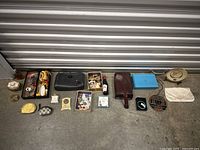 Wide overview of all items in the lot, including jewelry, small purses, and decorative collectibles arranged on the floor
