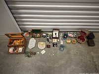 Overview of entire assorted vintage 925 sterling silver jewelry collection laid on floor, including boxes and coins
