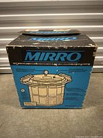 Original Mirro pressure cooker box with branding and animal graphic on the front.