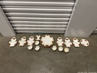 Wide shot showing all items of the Old Country Roses set arranged in a row on the floor.