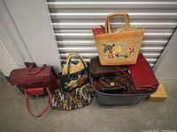 Photo showing six assorted purses and handbags in a storage bin and on nearby surfaces