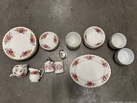 Full overview of porcelain rose garden dinnerware set arranged on floor
