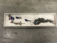 Lot of silver 925 jewelry in box including colorful cross pendant, small blue stone pendant, earrings, and bracelet with large blue and green stones.