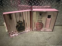 Pink gift box opened showing Victoria's Secret Bombshell perfume, lotion, and smaller perfume bottle inside.