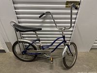 Full left side view of the vintage Meral bicycle illustrating frame design, seat, handlebars, and wheels.