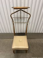 Full frontal view of the vintage wooden dressing chair showing padded seat and hanger with wooden tray.