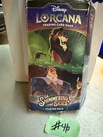 Photo of the Disney Lorcana Shimmering Skies Starter Deck with visible wear and rough box condition.