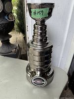 Front view of NHL Stanley Cup bank with visible Montreal Canadiens logo on the base and sticker label #159