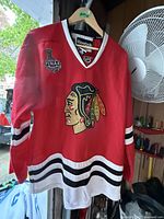 Front view of vintage red Reebok Chicago Blackhawks hockey jersey featuring the team logo and NHL Stanley Cup Final patch.
