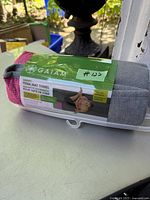 Yoga mat towel rolled and packaged in plastic wrap with green branded Gaiam label showing front view and product details.