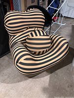 Front perspective of striped inflatable lounge chair and ball in storage area