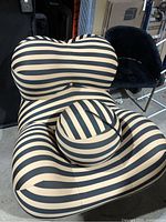 Front view of striped lounge chair with matching ball ottoman centered on the seat