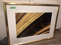 Framed print showing the full artwork and frame with wear visible on the metal frame.