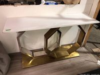 Front view of entire table showing white marble top and metal base