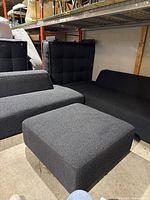 Front view showing bench module with low back and square ottoman in foreground