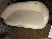 Front top view showing the white fabric sofa seat area with visible wear and stains.