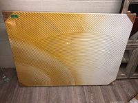 Full view of the wall art displaying golden yellow to off-white gradient with wavy embossed textured lines.
