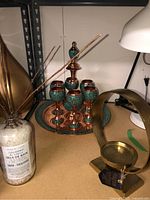 Full view of wine service including decanter, goblets, tray, candle holder, and bath salts on shelf