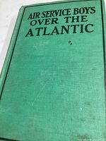 Front cover of the green hardcover book titled 'Air Service Boys Over the Atlantic' with some stains and minor damage.