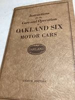 Photo of the booklet cover showing the title 'Instructions for the Care and Operation of Oakland Six Motor Cars, Eighth Edition'