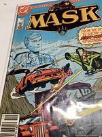 Photo of the front cover of the MASK comic book showing main characters and action scenes with vehicles firing lasers.