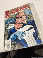 Cover photo of The Punisher comic book issue 18 showing the characters The Punisher and Kingpin in an action scene.