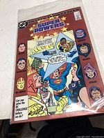 Photo of the comic book Super Powers #2 featuring DC superheroes and villains on the cover.