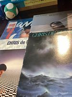 Four vinyl records stacked partially, three by Chris de Burgh with visible album covers.
