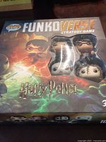 Front of sealed or boxed FunkoVerse Harry Potter strategy board game showing box art with Harry Potter characters in Funko Pop style.