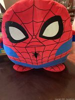 Front view of the large Spider-Man plush showing the face mask and spider emblem on the chest.