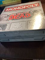 Monopoly The Walking Dead Survival Edition game box in metallic silver with branding