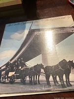 Front cover of The Doobie Brothers vinyl LP showing horse-drawn carriage under a large bridge with the album title in script.
