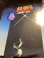 Front cover of Elvis Moody Blue album in blue vinyl sealed packaging with special limited edition sticker.