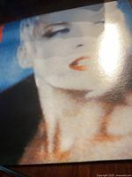 Close-up of the front cover of Eurythmics LP titled Be Yourself Tonight showing image of a woman.