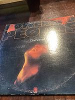 Front cover of the Powerful People vinyl album by Gino Vannelli with artwork showing a profile photo and the title in large letters.